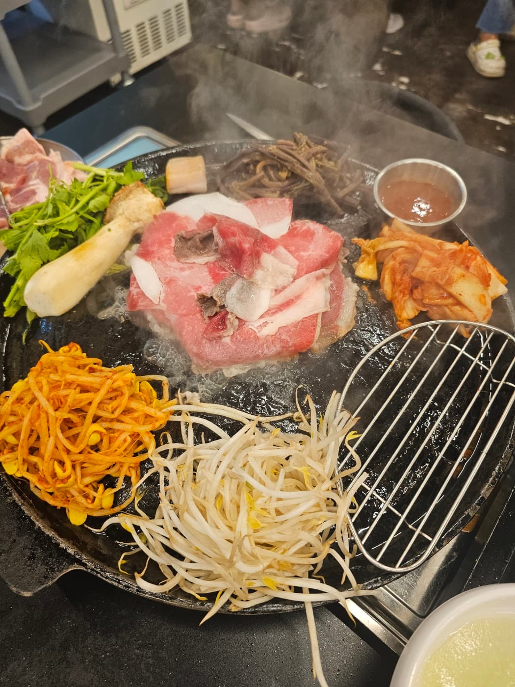 Samgyeopsal pork belly grilling at a Korean barbecue restaurant