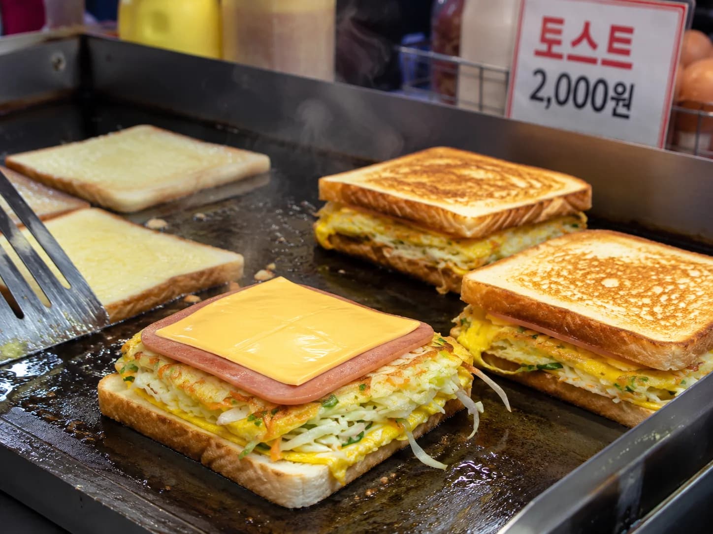 Korean street toast cooked on a flat griddle