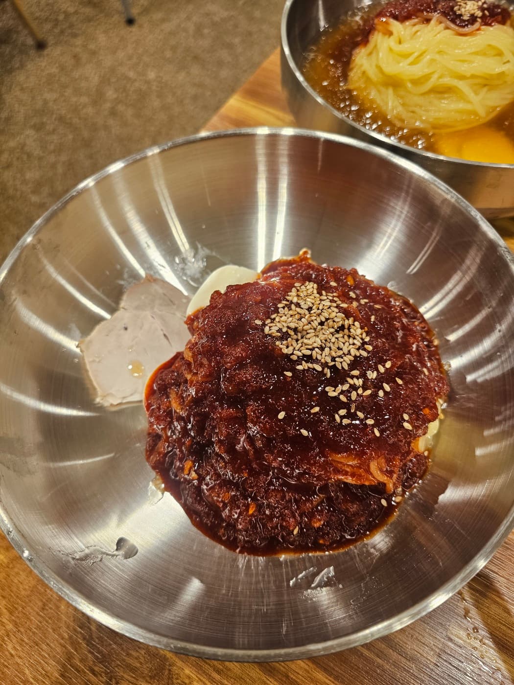 Bibim milmyeon with spicy red sauce and sesame seeds