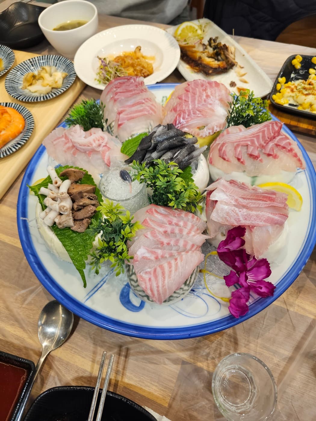 A large Korean seafood sashimi platter with side dishes
