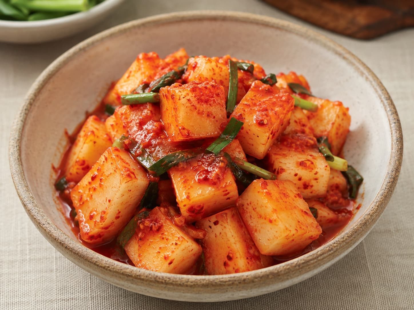 Kkakdugi, cubed radish kimchi, served in a small bowl